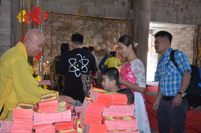 Granting lucky envelop on Tet occasion and handing in a python