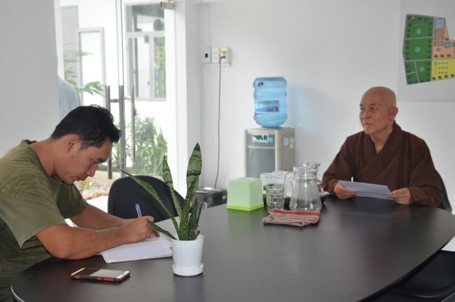 Granting lucky envelop on Tet occasion and handing in a python