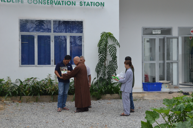 Granting lucky envelop on Tet occasion and handing in a python