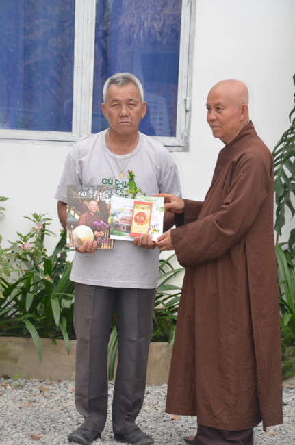 Granting lucky envelop on Tet occasion and handing in a python