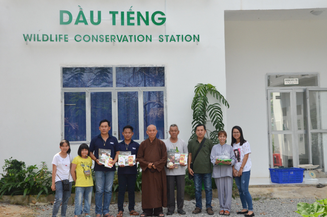 Granting lucky envelop on Tet occasion and handing in a python