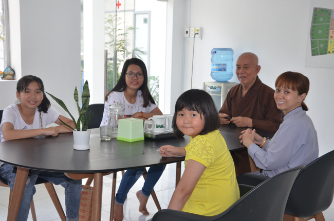 Granting lucky envelop on Tet occasion and handing in a python