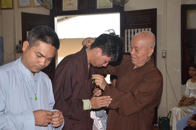 Granting lucky envelop on Tet occasion and handing in a python