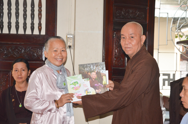 Granting lucky envelop on Tet occasion and handing in a python