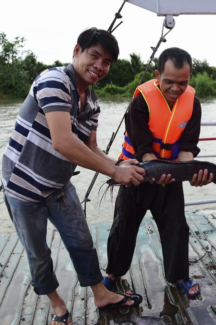 Freeing creatures at Ca Lang ferry and praying for rebirth.