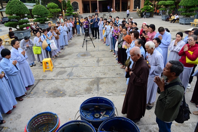 Freeing creatures at Ca Lang ferry and praying for rebirth.