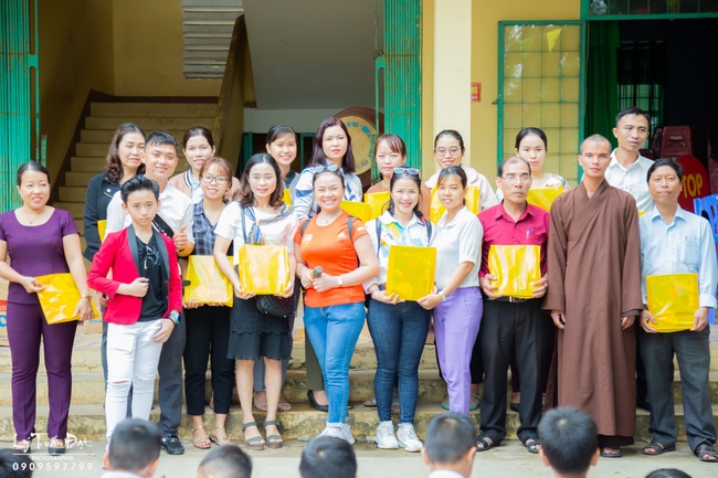 Giving gifts to pupils on occasion preparing Lunar New Year
