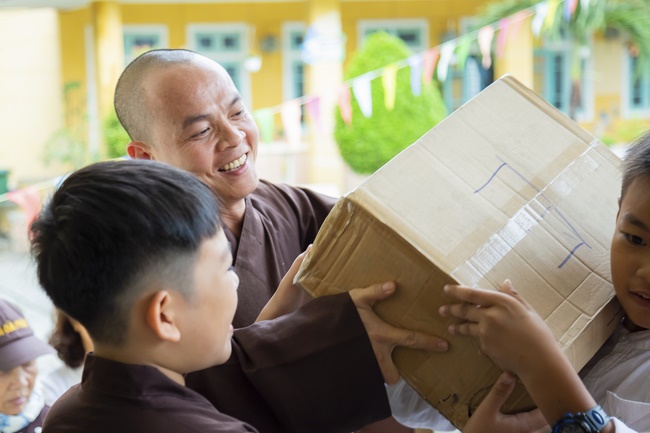 Giving gifts to pupils on occasion preparing Lunar New Year