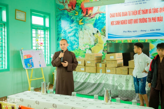 Giving gifts to pupils on occasion preparing Lunar New Year