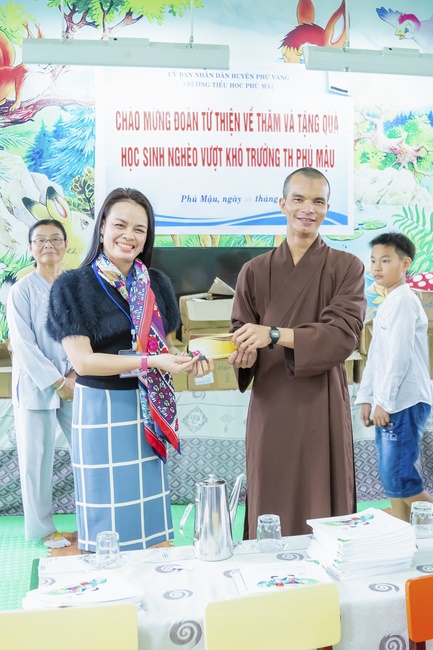 Giving gifts to pupils on occasion preparing Lunar New Year