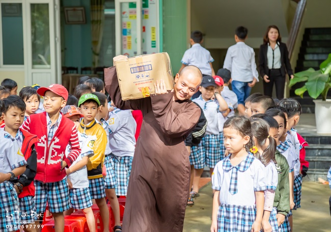 Giving gifts to pupils on occasion preparing Lunar New Year