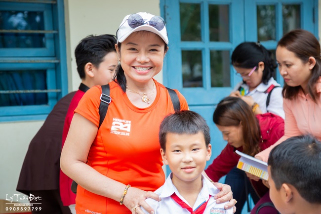 Giving gifts to pupils on occasion preparing Lunar New Year