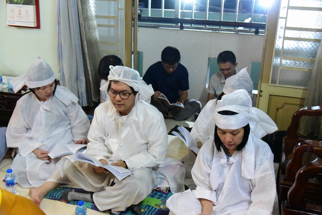 Praying for rebirth in District 11 and Hoc Mon