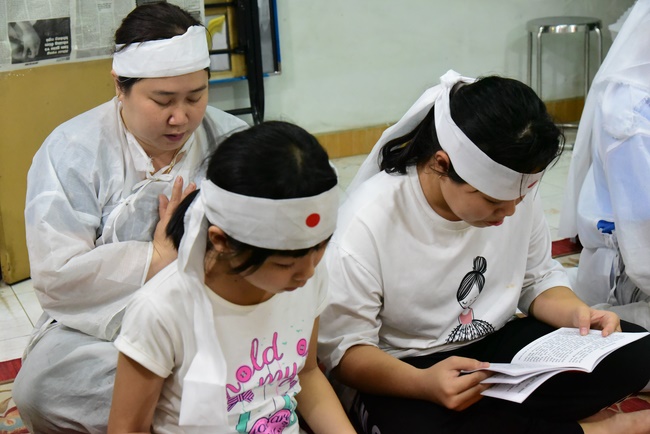 Praying for rebirth in District 11 and Hoc Mon