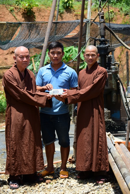 Offering money to build wells at Bao Phap Pagoda, Lam Dong