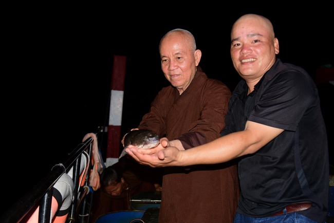 Liberating creatures at Binh My ferry and praying for peacefulness.