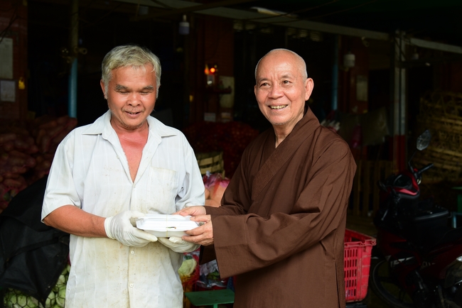 Giving lunch portions at Hoc Mon Wholesale Market and The rite praying for rebirth in Tay Ninh
