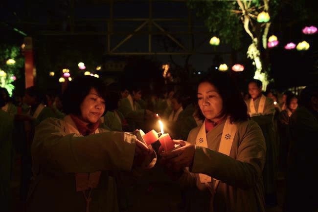 Attending the floral candle light ceremony on the Shakyamuni Buddha's Attainment Day at Bang Pagoda - Ha Noi