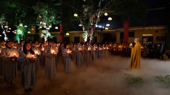 Attending the floral candle light ceremony on the Shakyamuni Buddha's Attainment Day at Bang Pagoda - Ha Noi
