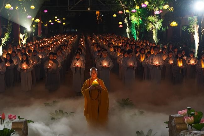 Attending the floral candle light ceremony on the Shakyamuni Buddha's Attainment Day at Bang Pagoda - Ha Noi