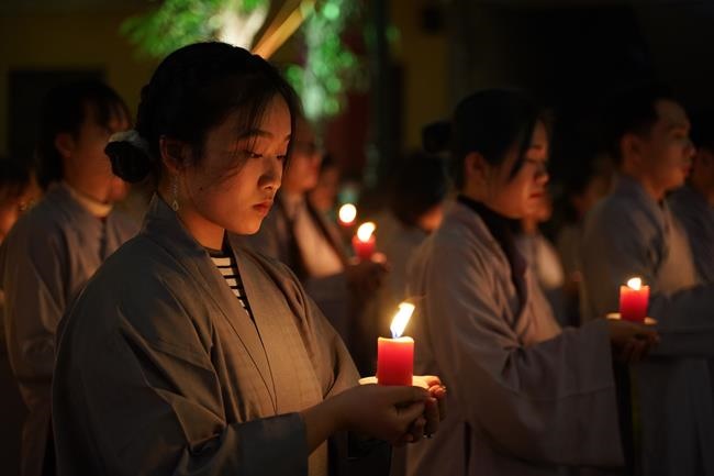 Attending the floral candle light ceremony on the Shakyamuni Buddha's Attainment Day at Bang Pagoda - Ha Noi