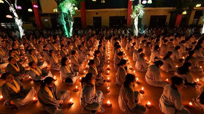 Attending the floral candle light ceremony on the Shakyamuni Buddha's Attainment Day at Bang Pagoda - Ha Noi