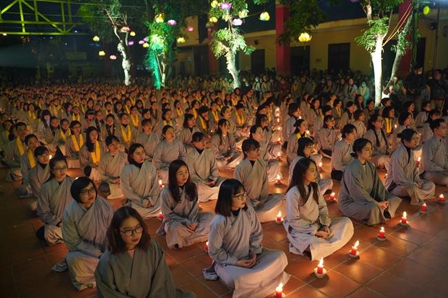 Attending the floral candle light ceremony on the Shakyamuni Buddha's Attainment Day at Bang Pagoda - Ha Noi