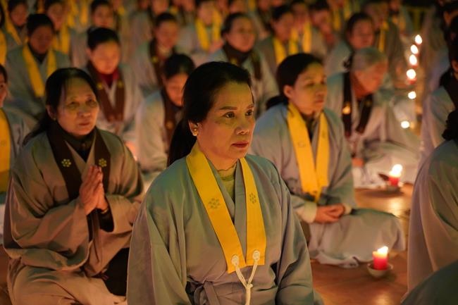 Attending the floral candle light ceremony on the Shakyamuni Buddha's Attainment Day at Bang Pagoda - Ha Noi