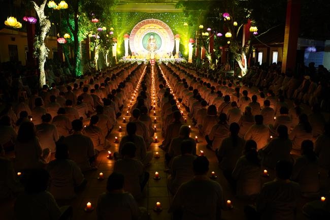 Attending the floral candle light ceremony on the Shakyamuni Buddha's Attainment Day at Bang Pagoda - Ha Noi