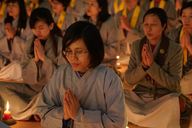 Attending the floral candle light ceremony on the Shakyamuni Buddha's Attainment Day at Bang Pagoda - Ha Noi