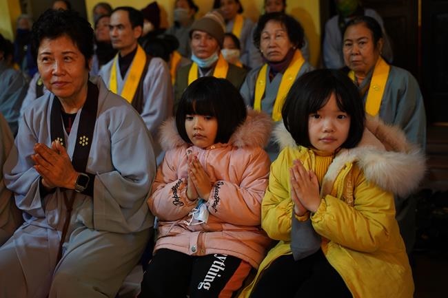 Attending the floral candle light ceremony on the Shakyamuni Buddha's Attainment Day at Bang Pagoda - Ha Noi