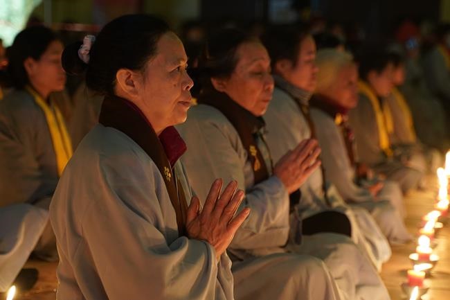 Attending the floral candle light ceremony on the Shakyamuni Buddha's Attainment Day at Bang Pagoda - Ha Noi