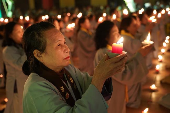 Attending the floral candle light ceremony on the Shakyamuni Buddha's Attainment Day at Bang Pagoda - Ha Noi