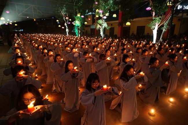 Attending the floral candle light ceremony on the Shakyamuni Buddha's Attainment Day at Bang Pagoda - Ha Noi