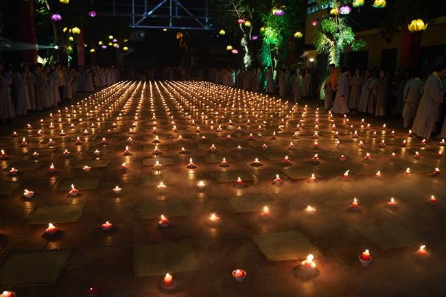 Attending the floral candle light ceremony on the Shakyamuni Buddha's Attainment Day at Bang Pagoda - Ha Noi