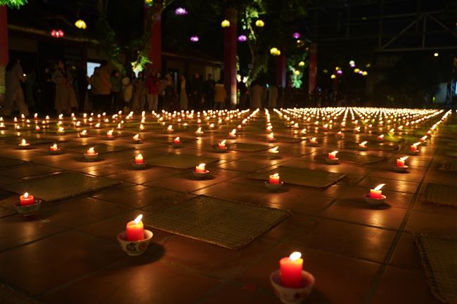 Attending the floral candle light ceremony on the Shakyamuni Buddha's Attainment Day at Bang Pagoda - Ha Noi