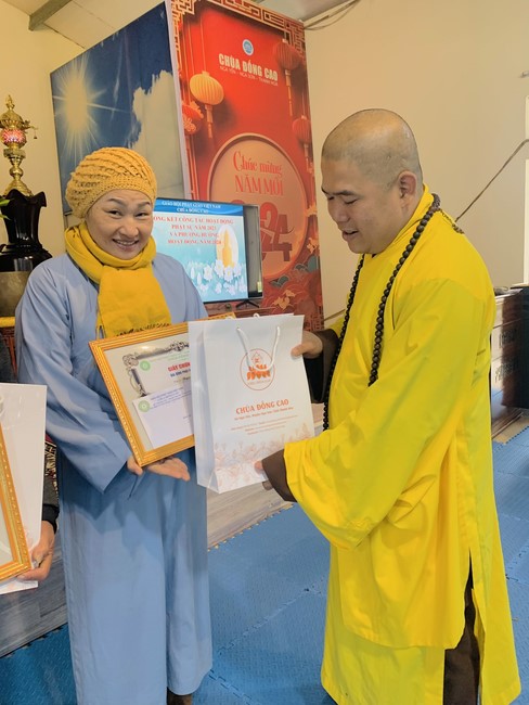 Year End Practice, a past year closing program, giving Tet gifts at Dong Cao pagoda