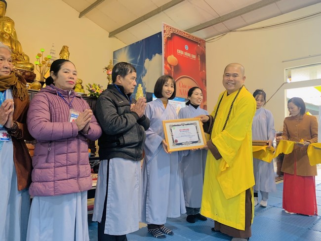 Year End Practice, a past year closing program, giving Tet gifts at Dong Cao pagoda